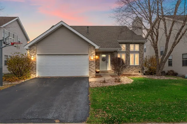 a front view of a house with patio and garden