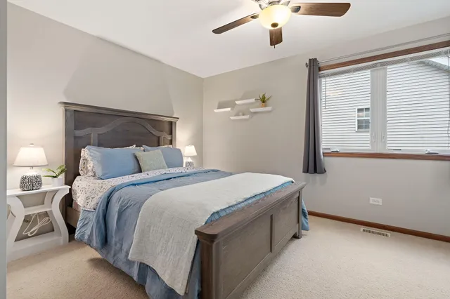 a bedroom with a bed and lamp