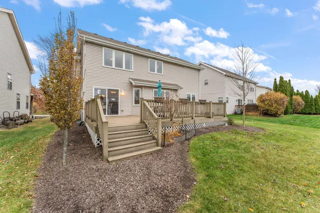a backyard of a house with table and chairs