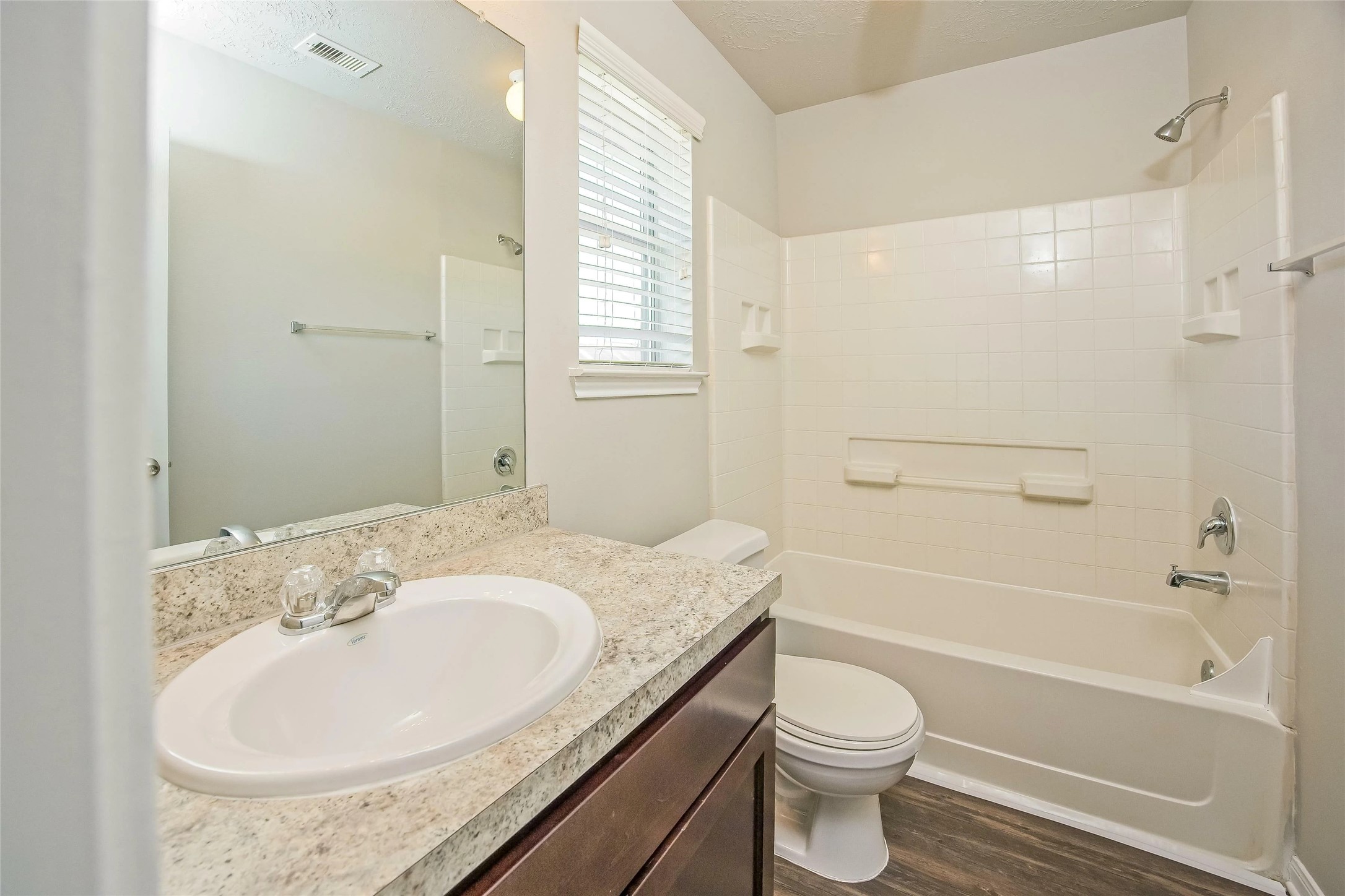 9719 Elia Court Houston, TX 77044 - Photo 11 of 12 a bathroom with a granite countertop sink toilet and shower