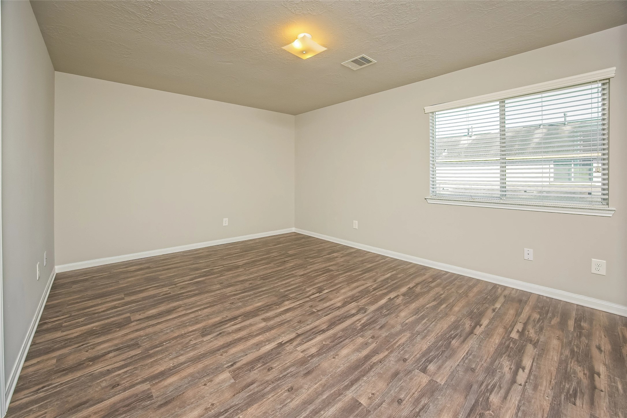 9719 Elia Court Houston, TX 77044 - Photo 9 of 12 wooden floor in an empty room with a window