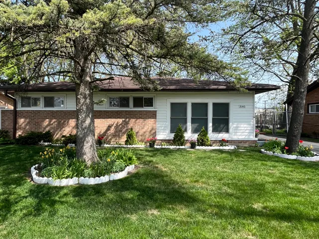 a view of a house with backyard sitting area and garden