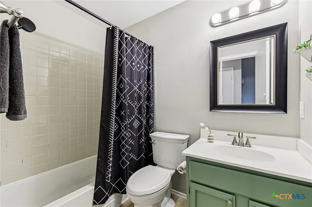 a white toilet sitting next to a bathroom sink