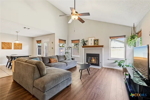 a living room with furniture a fireplace and a flat screen tv