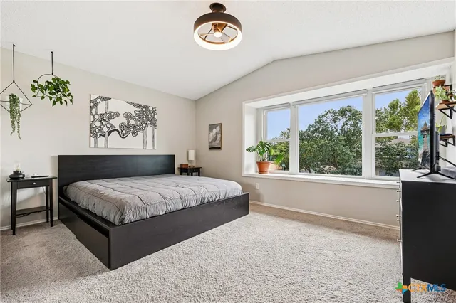 a spacious bedroom with a bed and a window