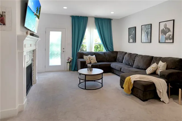 a living room with furniture fireplace and window