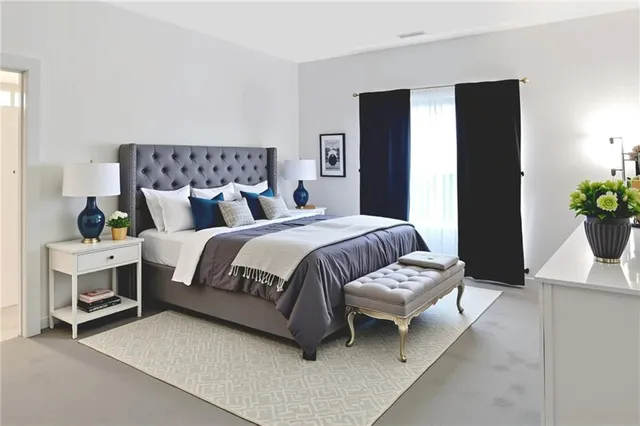 a bedroom with a bed and a potted plant