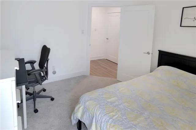 a bedroom with a bed and a chair