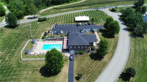 an aerial view of residential houses with outdoor space and street view