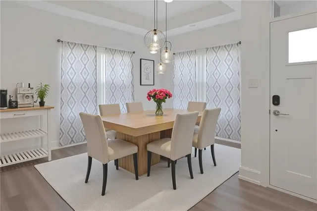 a view of a dining room with furniture window and wooden floor