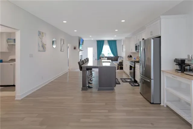 a view of a kitchen with refrigerator and windows