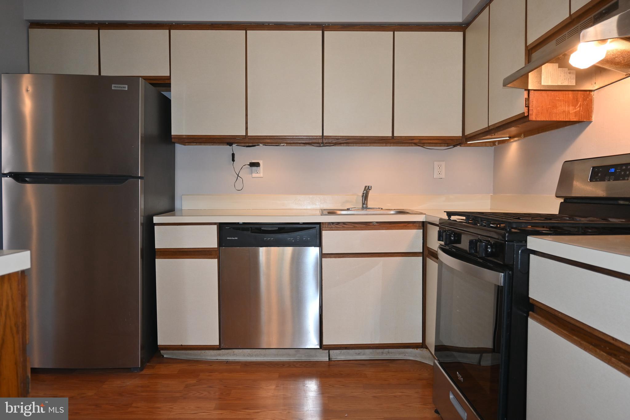 613 St Anthony Lane Upper Darby, PA 19082 - Photo 14 of 30 a kitchen with a sink a refrigerator and cabinets