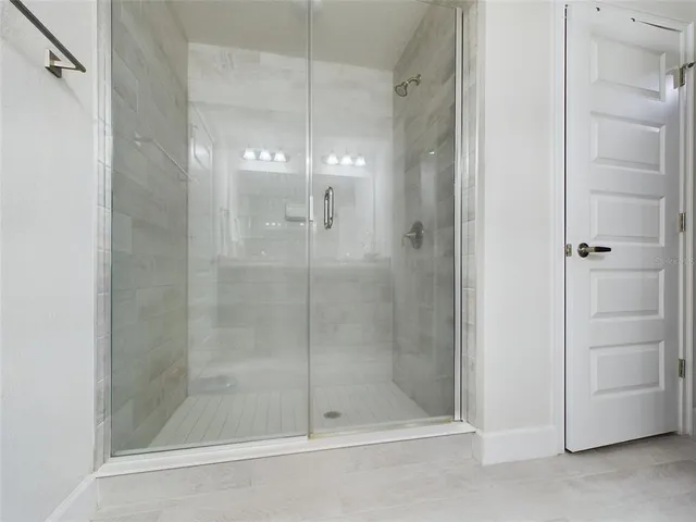 a bathroom with a glass shower door