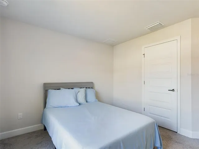 a bedroom with a bed and a closet