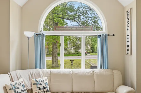 a bed room with a bed and a large window