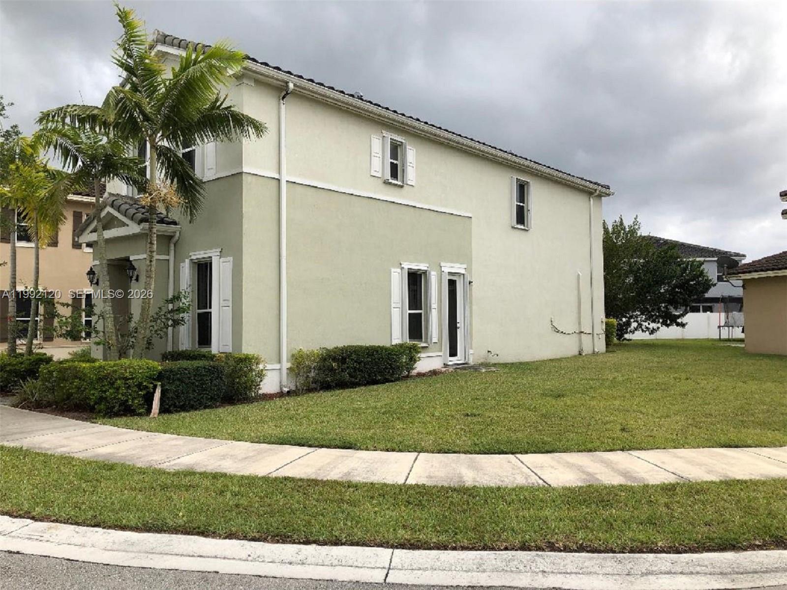 17000 Southwest 90th Terrace Miami, FL 33196 - Photo 13 of 56 a view of a white house next to a yard