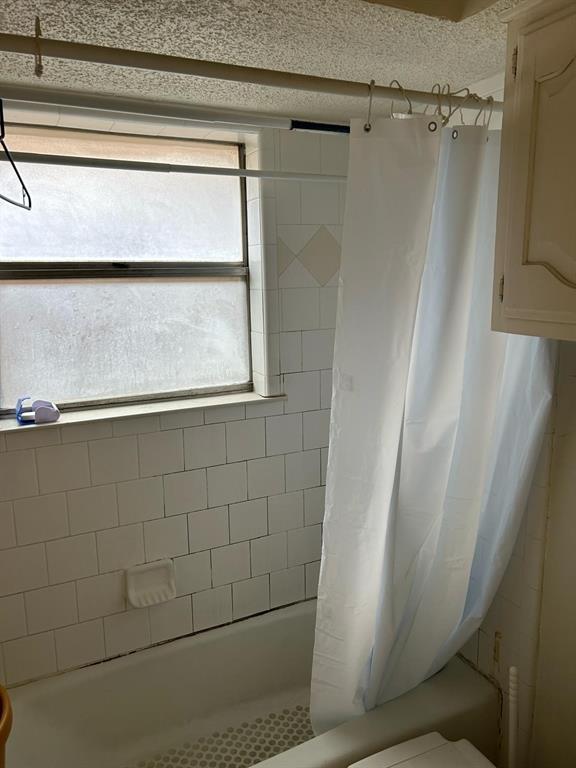 13114 Halwin Circle Dallas, TX 75243 - Photo 11 of 23 a bathroom with a glass door shower and a bathtub