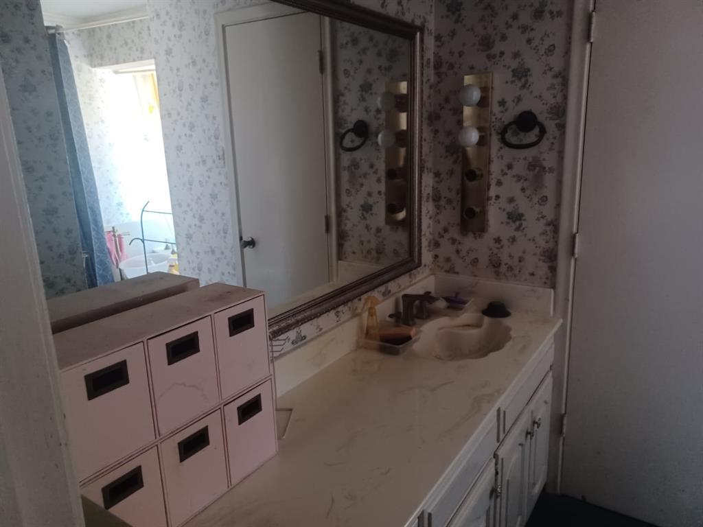 13114 Halwin Circle Dallas, TX 75243 - Photo 15 of 23 a bathroom with a tub sink and mirror