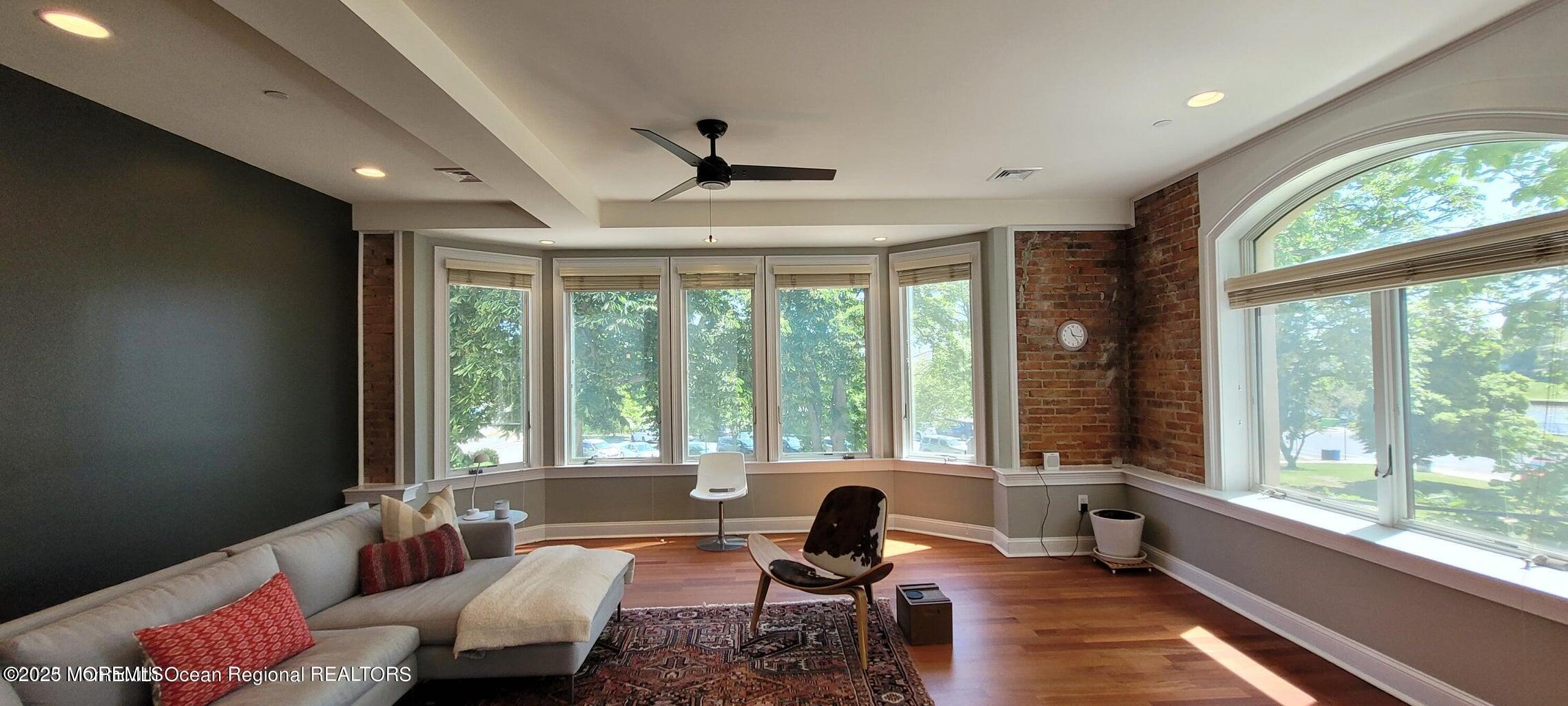 508 Cookman Avenue, Unit 204 Asbury Park, NJ 07712 - Photo 3 of 8 a living room with furniture and floor to ceiling windows