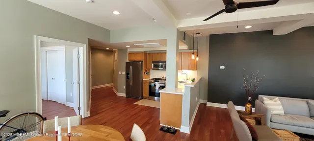 a view of a livingroom with furniture and hardwood floor