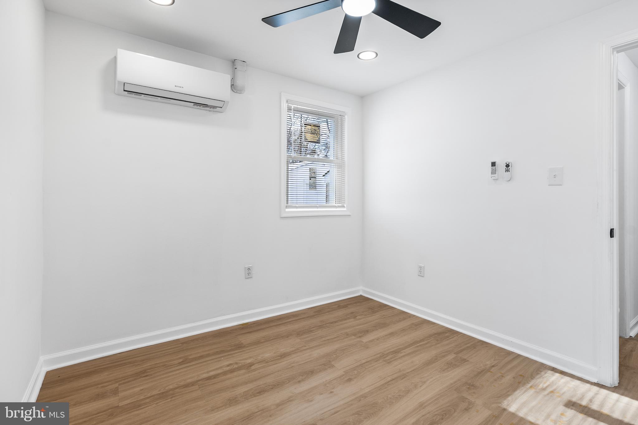 114 Brown Street Elkton, MD 21921 - Photo 11 of 15 an empty room with wooden floor and ceiling fan