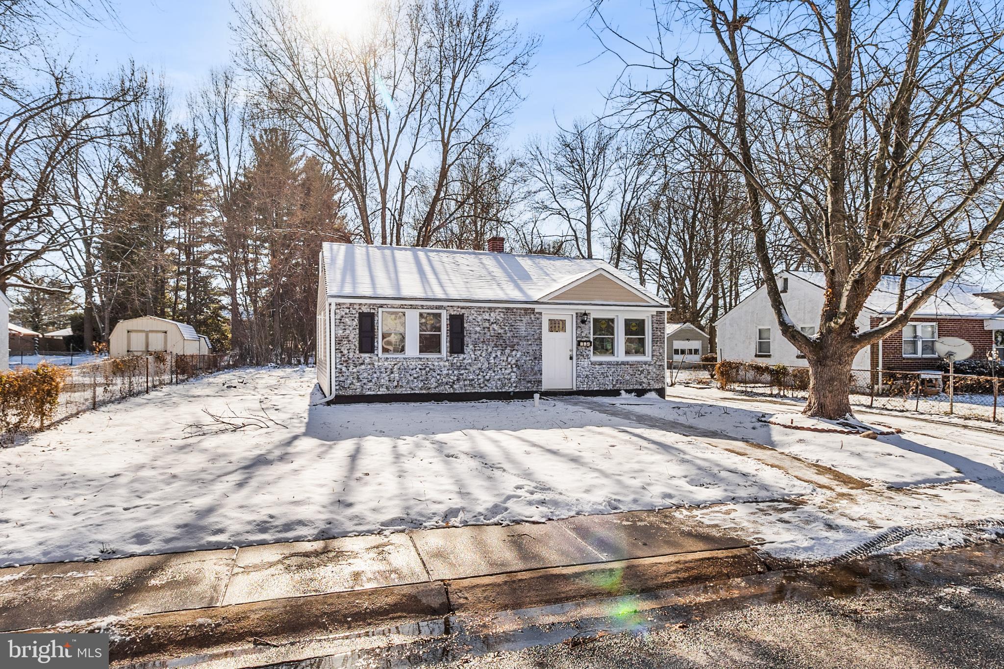 114 Brown Street Elkton, MD 21921 - Photo 2 of 15 a front view of a house with a yard covered in snow