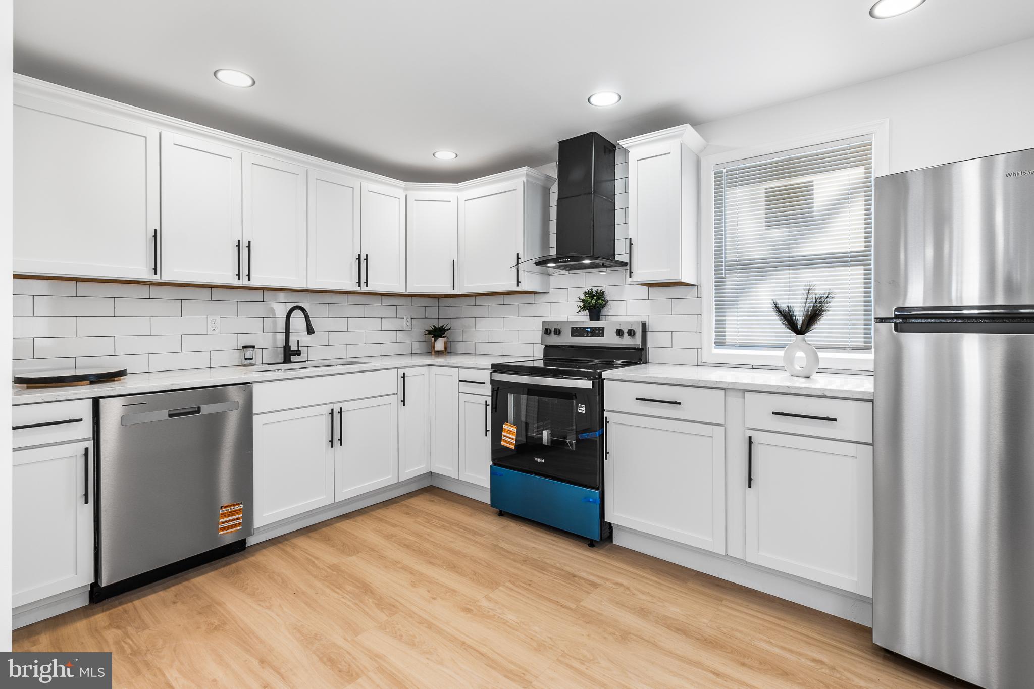 114 Brown Street Elkton, MD 21921 - Photo 7 of 15 a kitchen with white cabinets and white appliances