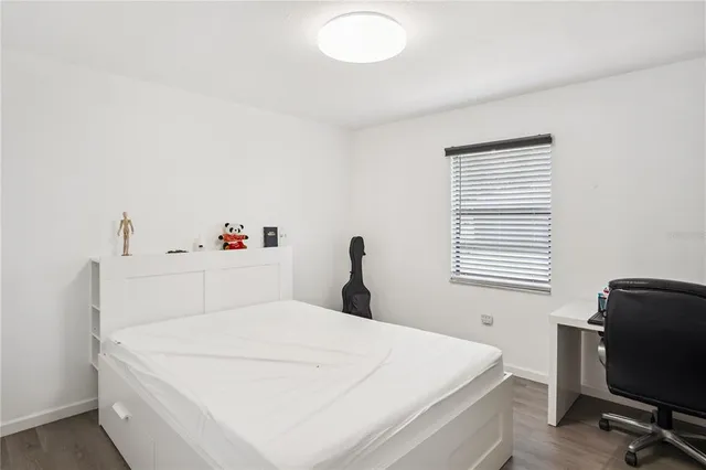 a bedroom with a bed and a chair