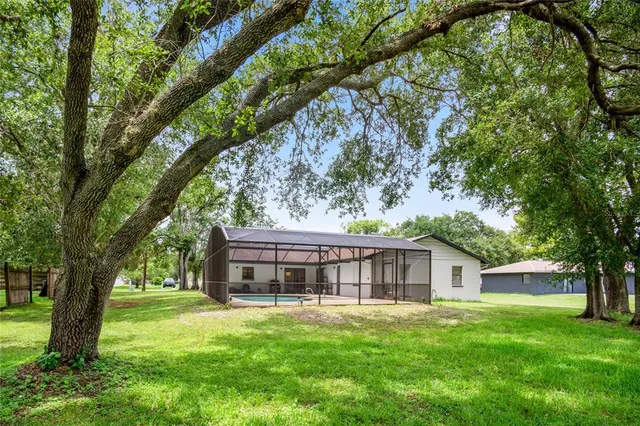 a view of house with a yard