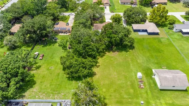an aerial view of house with yard swimming pool and outdoor seating