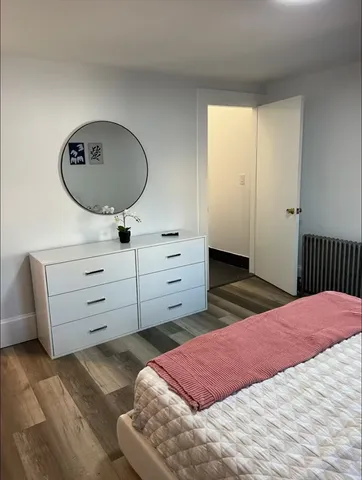 a bedroom with a bed and a dresser