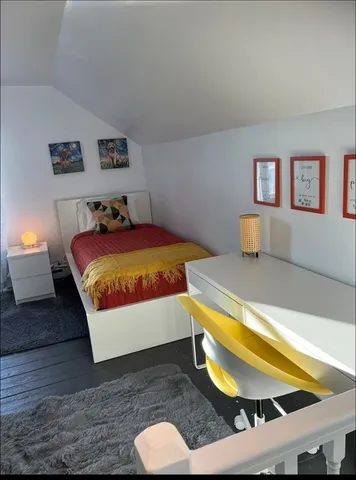 a bedroom with a bed and a couch