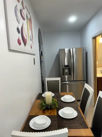 a kitchen with a table and chairs
