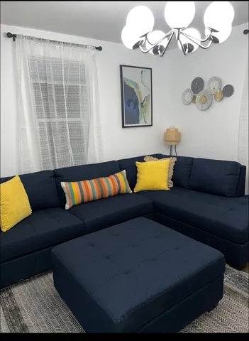 a living room with furniture and a mirror