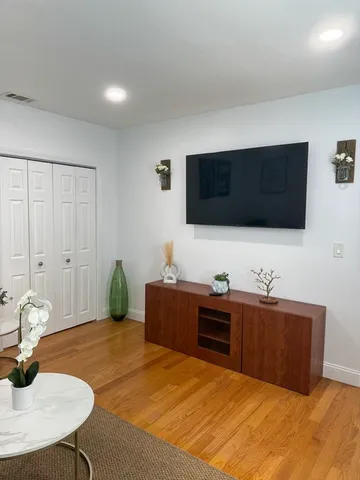 a bedroom with a bed and a flat screen tv