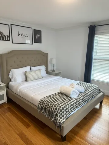 a bedroom with a bed and window