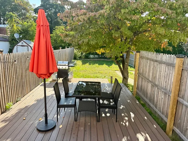 a view of a deck with a table and chairs