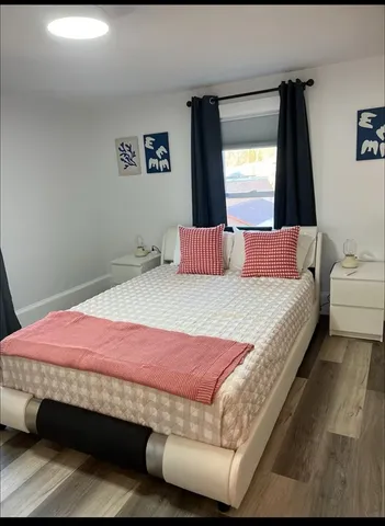 a bedroom with a bed and window