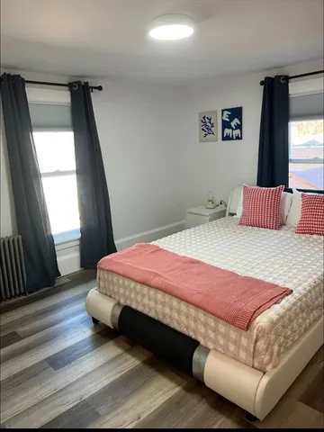 a bedroom with a bed and window