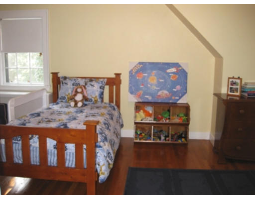 156 Thornton Road Needham, MA 02492 - Photo 7 of 12 a bed sitting in a bedroom next to a window with wooden floor