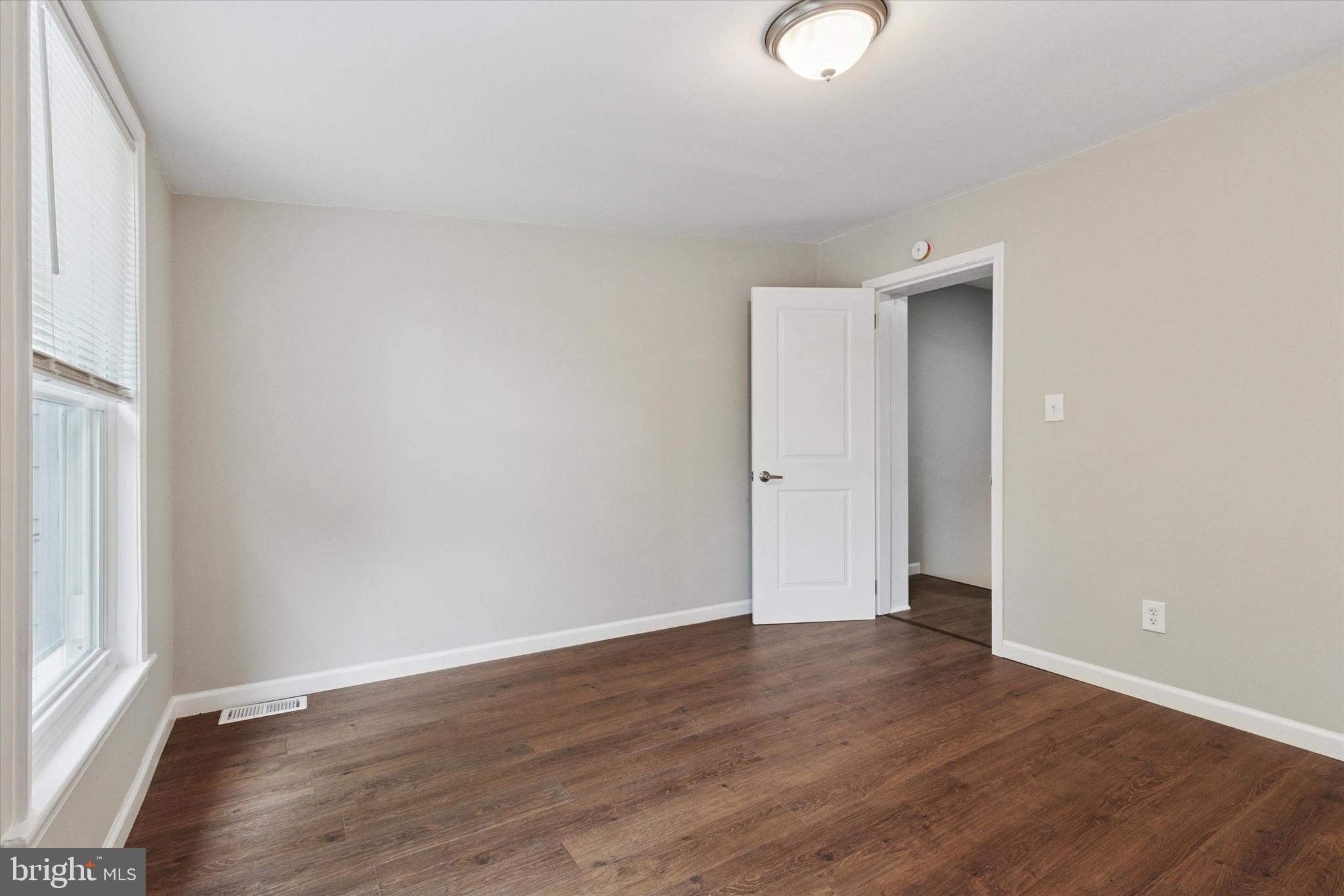 234 Main Street Hellertown, PA 18055 - Photo 11 of 13 an empty room with wooden floor and windows