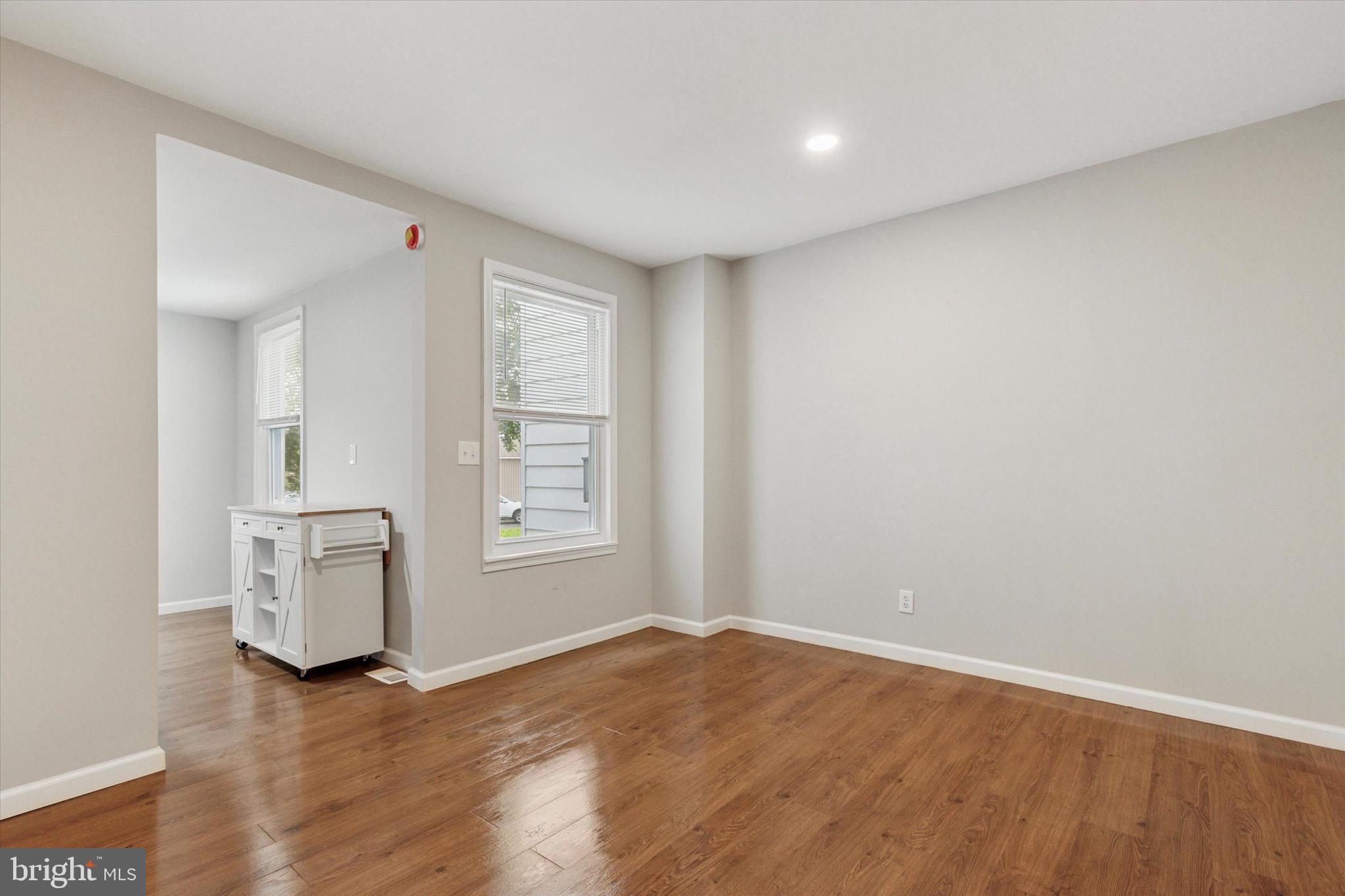 234 Main Street Hellertown, PA 18055 - Photo 4 of 13 an empty room with wooden floor and window