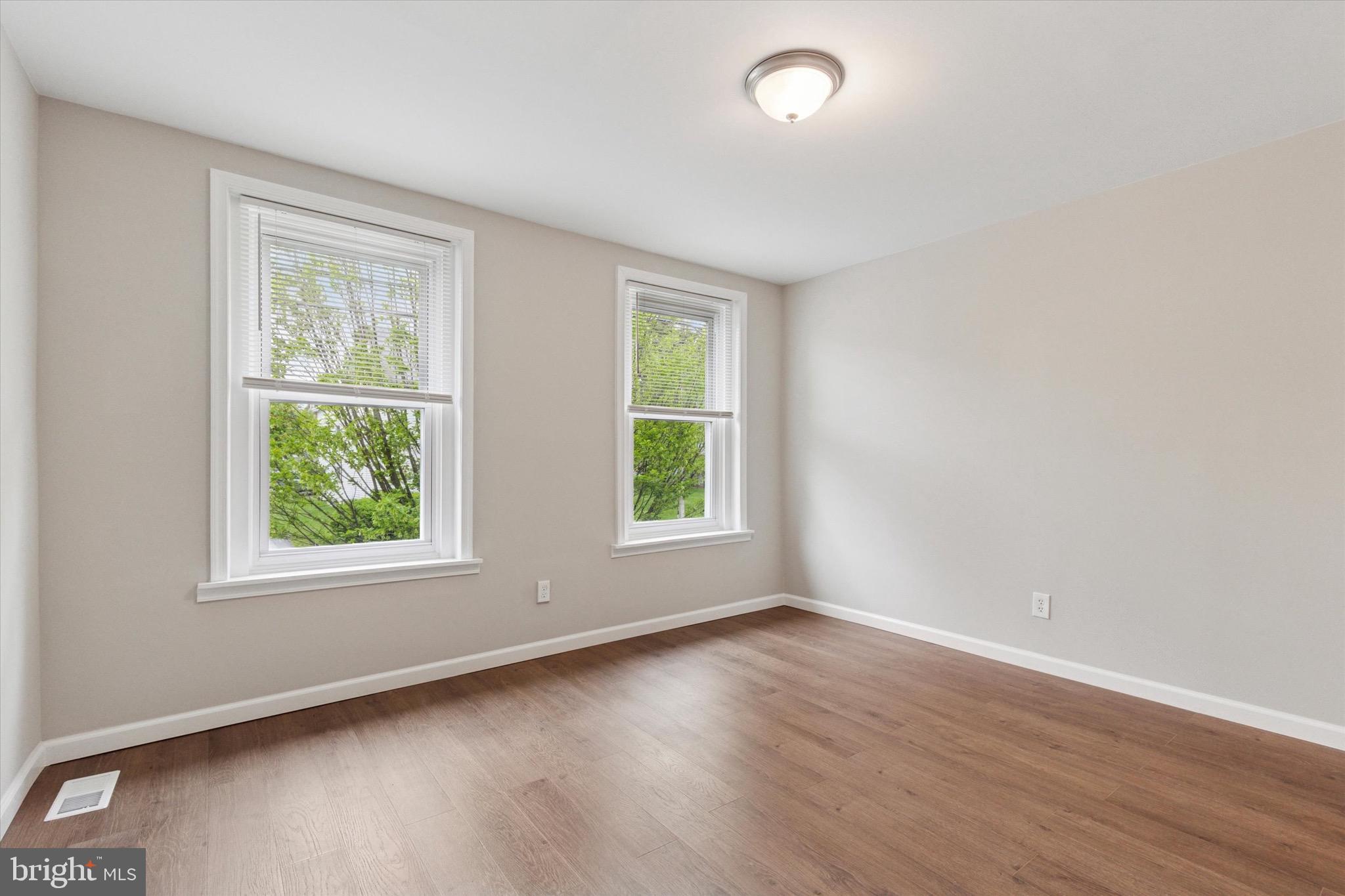 234 Main Street Hellertown, PA 18055 - Photo 7 of 13 an empty room with wooden floor and windows
