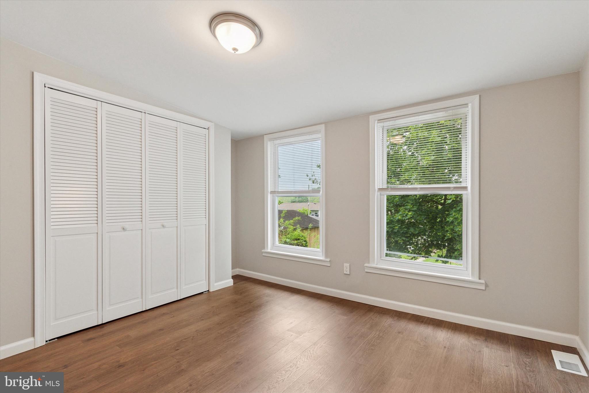 234 Main Street Hellertown, PA 18055 - Photo 8 of 13 an empty room with wooden floor and windows