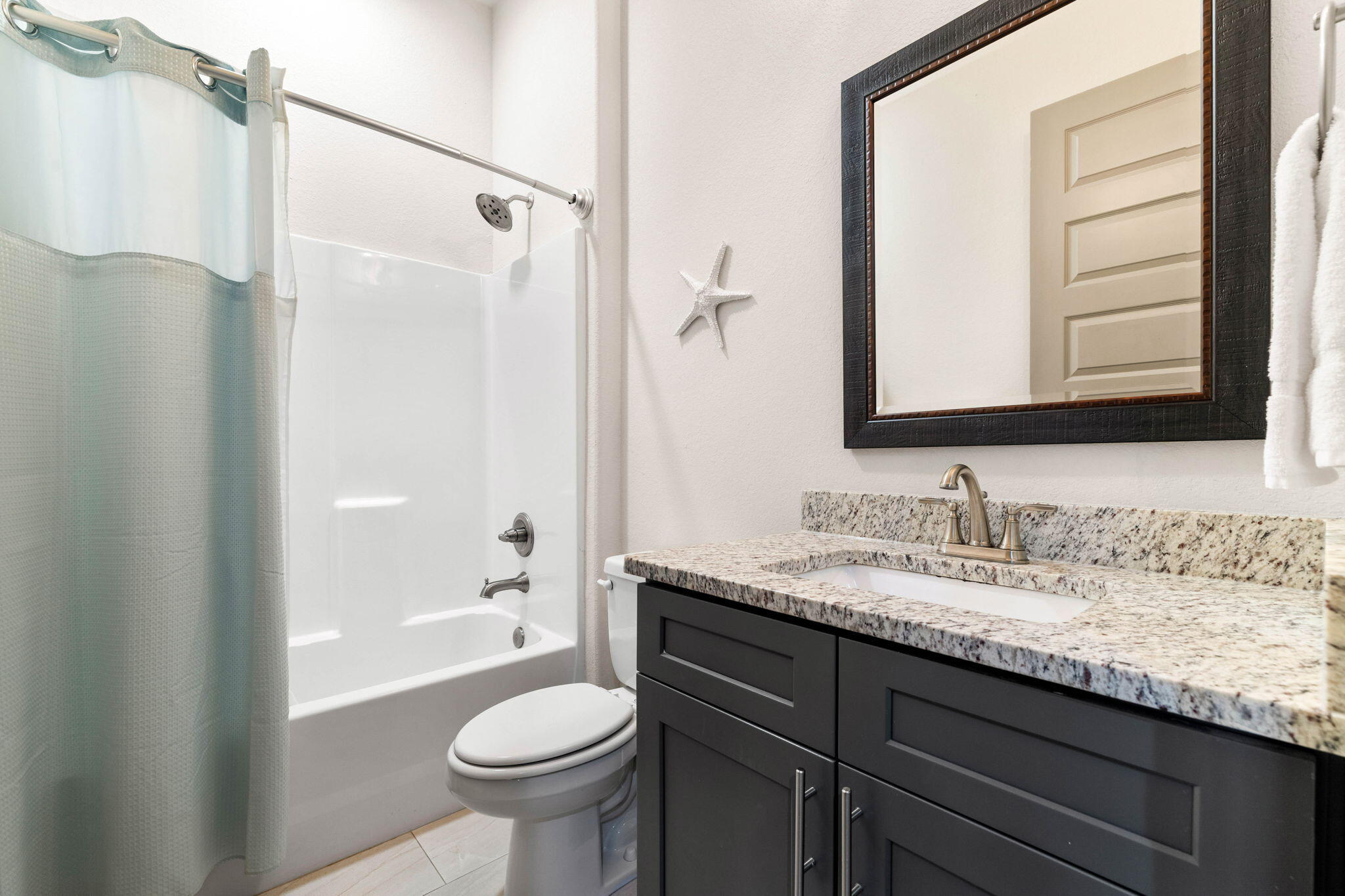 267 Gulfview Circle Santa Rosa Beach, FL 32459 - Photo 17 of 46 a bathroom with a granite countertop sink toilet and shower