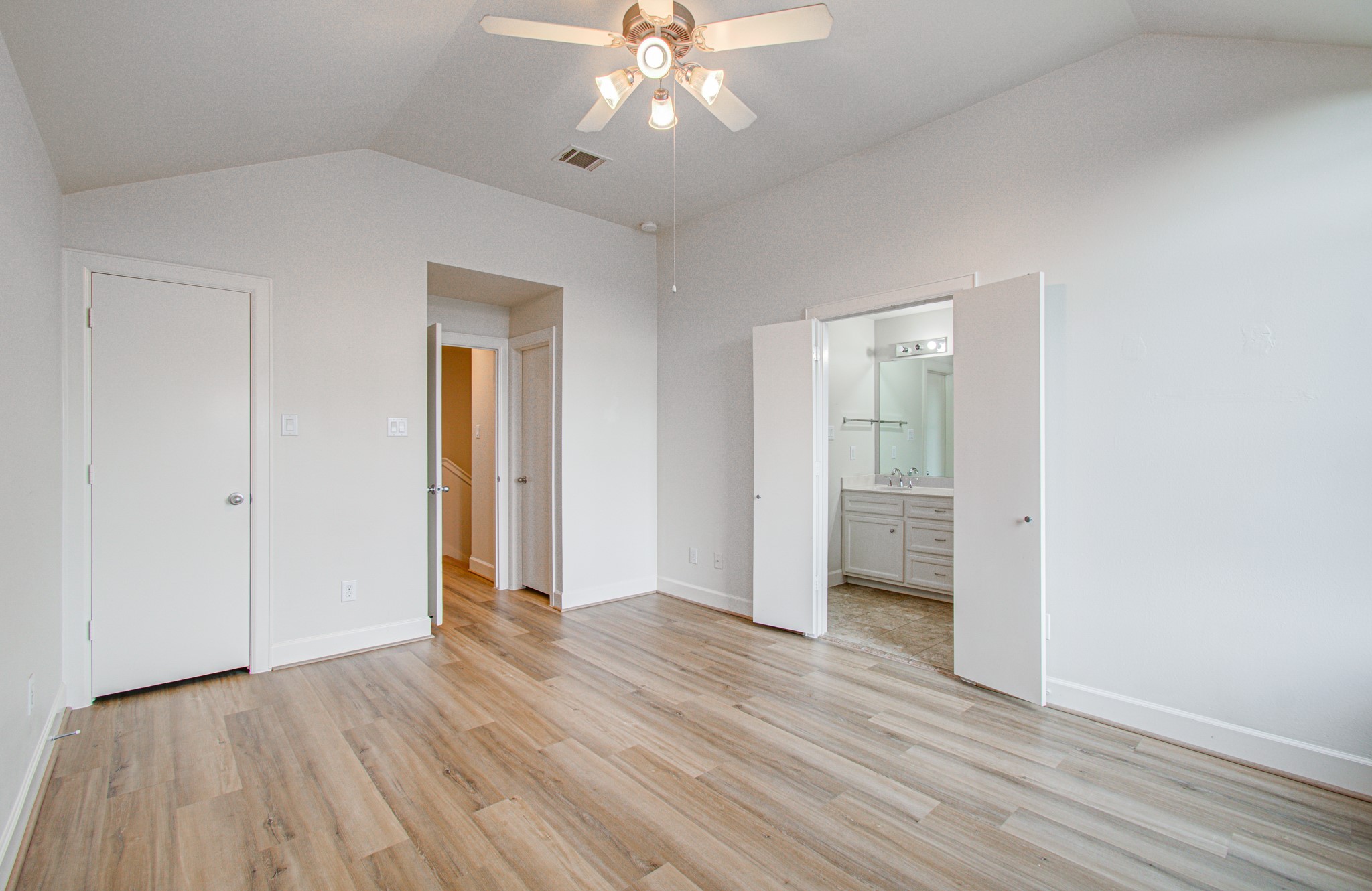 624 East 39th Street Houston, TX 77022 - Photo 22 of 37 a view of an empty room with wooden floor and a ceiling fan