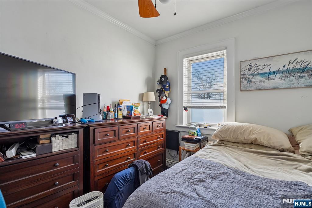 82 Hackensack Street, Unit 6 Wood-Ridge, NJ 07075 - Photo 13 of 28 a bedroom with a bed and a dresser in it