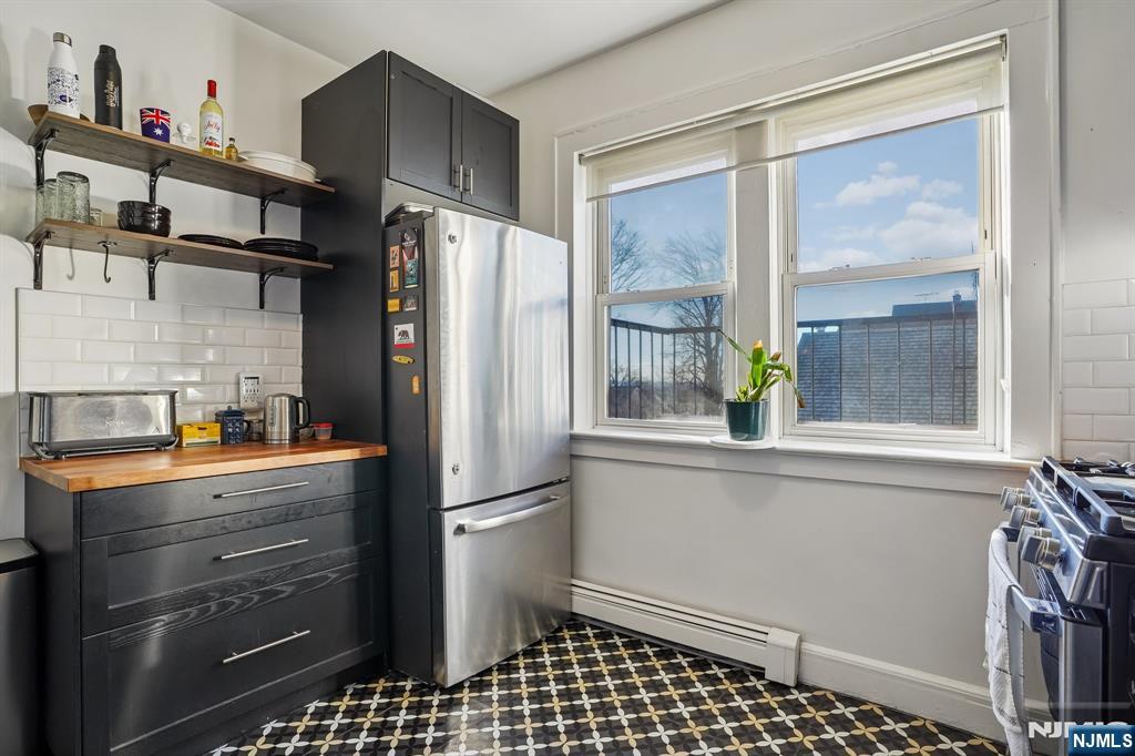 82 Hackensack Street, Unit 6 Wood-Ridge, NJ 07075 - Photo 9 of 28 a kitchen with stainless steel appliances a refrigerator and a stove