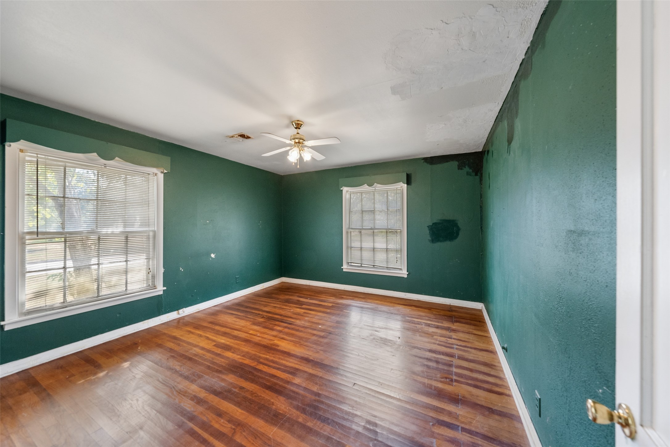 810 Main Street Hempstead, TX 77445 - Photo 25 of 32 Additional bedroom with hardwood flooring, multiple windows, and versatile space for a bedroom, office, or guest room.