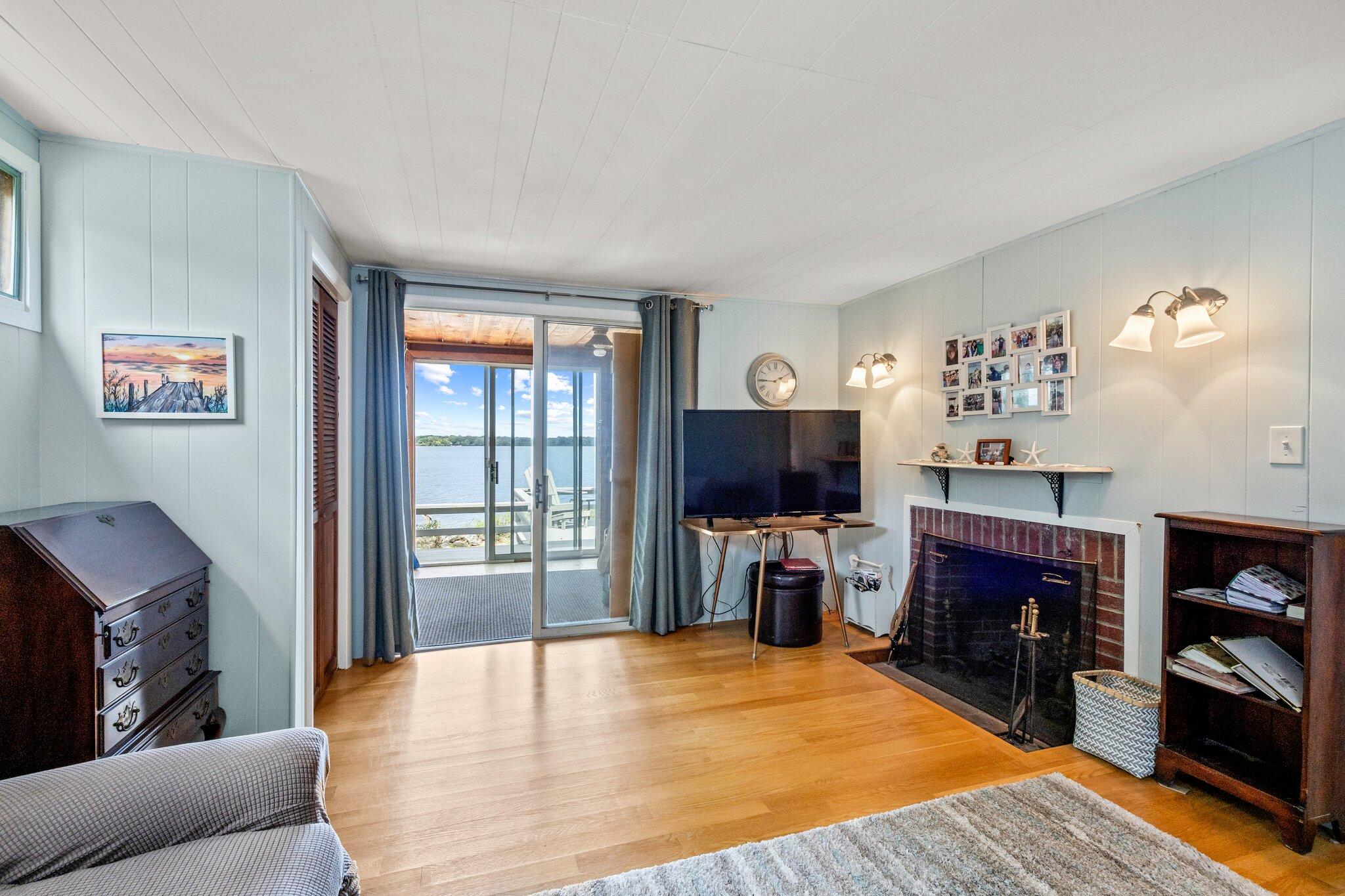 159 Willow Run Drive Centerville, MA 02632 - Photo 15 of 34 a living room with furniture a flat screen tv and a fireplace